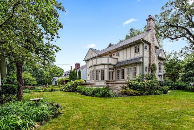 2423 Harrison St, Evanston, IL 60201 - rear view of house featuring a chimney, a yard, a balcony, and french doors