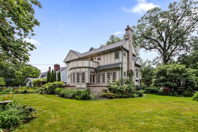 2423 Harrison St, Evanston, IL 60201 - back of property with a balcony, french doors, a chimney, and a yard