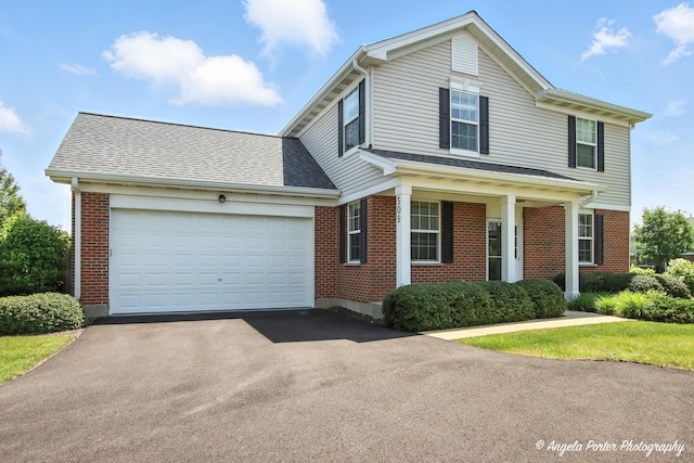 509 Legend Ln, Mchenry, IL 60050 - traditional-style house featuring brick siding, driveway, an attached garage, and a shingled roof