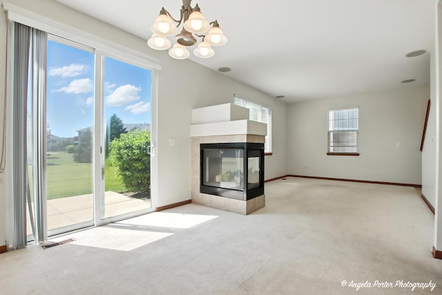 509 Legend Ln, Mchenry, IL 60050 - unfurnished living room featuring a multi sided fireplace, a chandelier, and carpet flooring