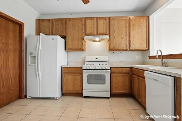 509 Legend Ln, Mchenry, IL 60050 - kitchen with white appliances, under cabinet range hood, light countertops, brown cabinetry, and a ceiling fan
