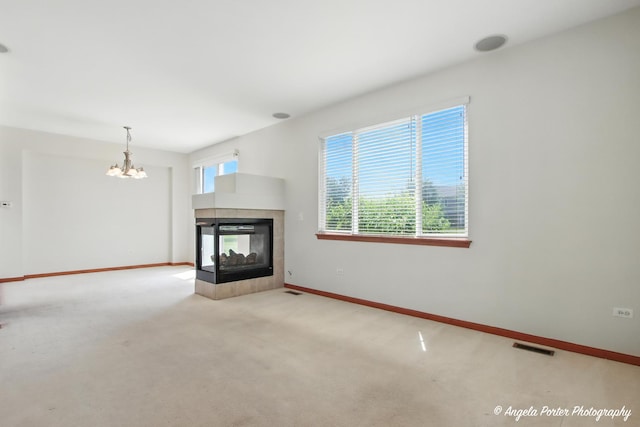509 Legend Ln, Mchenry, IL 60050 - unfurnished living room with a chandelier, a tile fireplace, and carpet floors