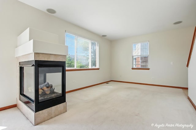 509 Legend Ln, Mchenry, IL 60050 - unfurnished living room featuring a multi sided fireplace, healthy amount of natural light, and carpet floors