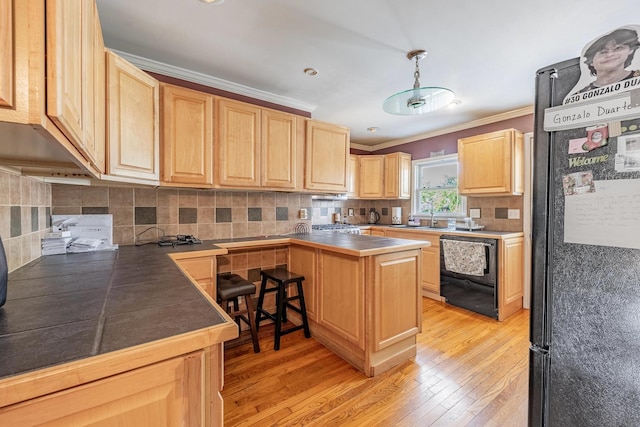 4941 W 119th St, Alsip, IL 60803 - kitchen featuring light brown cabinetry, black appliances, light wood-style floors, ornamental molding, and decorative backsplash
