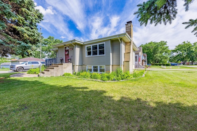 4941 W 119th St, Alsip, IL 60803 - view of front facade featuring a chimney and a front lawn