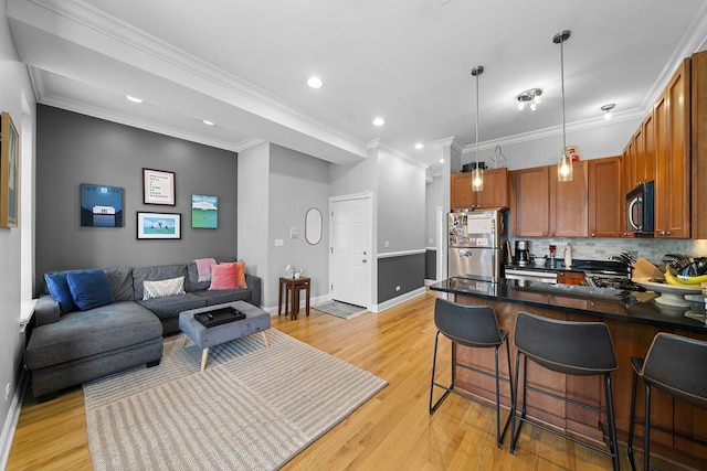 1849 W Superior St Unit 3, Chicago, IL 60622 - kitchen with freestanding refrigerator, dark countertops, tasteful backsplash, a kitchen breakfast bar, and light wood-style flooring