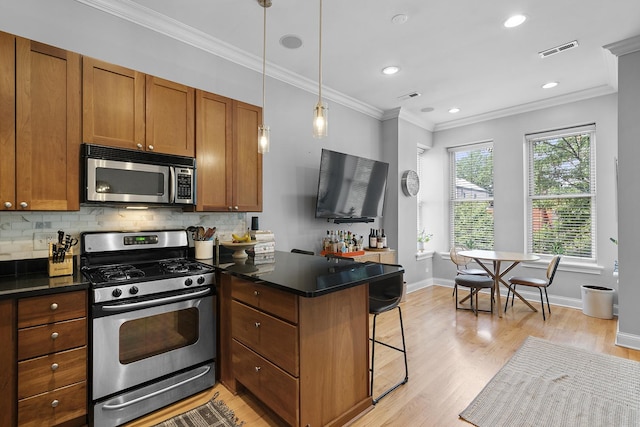 1849 W Superior St Unit 3, Chicago, IL 60622 - kitchen featuring stainless steel appliances, light wood-style flooring, a peninsula, brown cabinets, and ornamental molding
