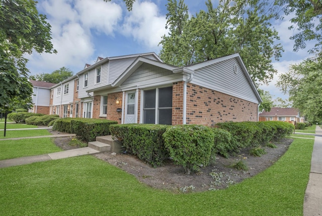 4018 Oxford Ct, Streamwood, IL 60107 - view of front of house featuring brick siding, a front lawn, and a chimney