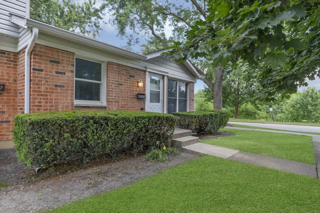 4018 Oxford Ct, Streamwood, IL 60107 - doorway to property featuring brick siding and a yard