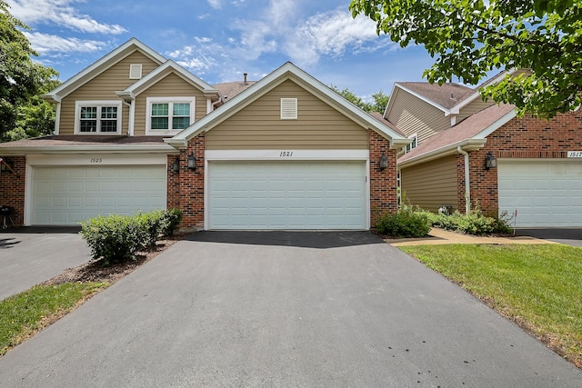 1521 Whitman Ct, Schaumburg, IL 60173 - view of front of home with brick siding, asphalt driveway, and a garage
