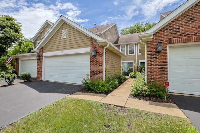 1521 Whitman Ct, Schaumburg, IL 60173 - view of front of home featuring brick siding and driveway