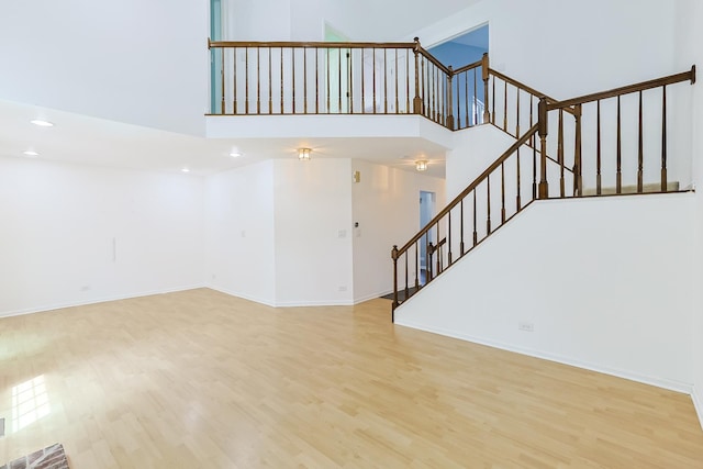 1521 Whitman Ct, Schaumburg, IL 60173 - unfurnished living room with wood finished floors, stairs, recessed lighting, and a towering ceiling