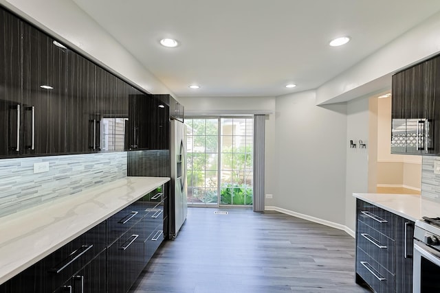 1521 Whitman Ct, Schaumburg, IL 60173 - kitchen featuring modern cabinets, decorative backsplash, wood finished floors, appliances with stainless steel finishes, and dark cabinetry