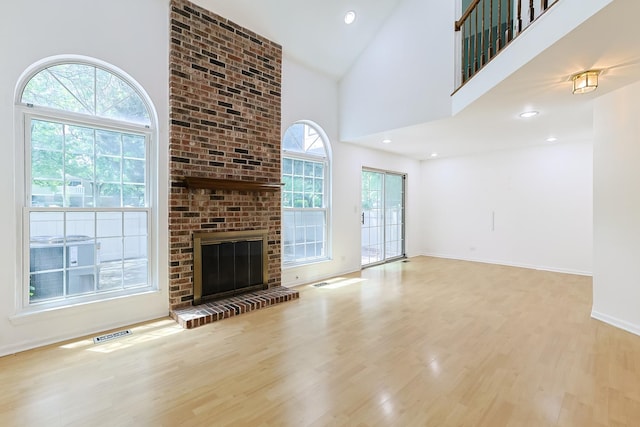 1521 Whitman Ct, Schaumburg, IL 60173 - unfurnished living room with wood finished floors, a fireplace, a towering ceiling, and recessed lighting