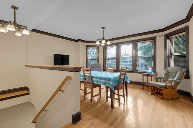 5609 N Mango Ave Unit 1W, Chicago, IL 60646 - dining space featuring light wood-type flooring, a chandelier, and crown molding