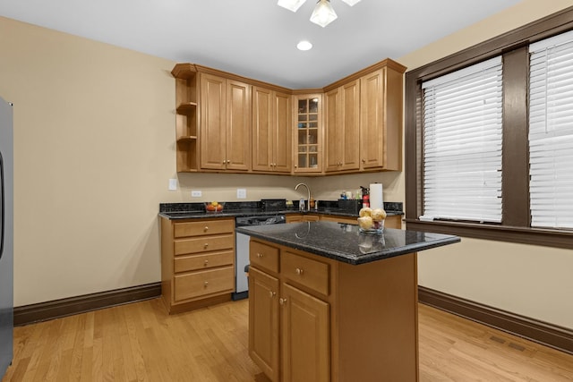 5609 N Mango Ave Unit 1W, Chicago, IL 60646 - kitchen featuring dishwashing machine, light wood-style flooring, a center island, a skylight, and recessed lighting
