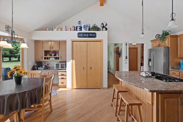 344 Prairie Ave, Winthrop Harbor, IL 60096 - kitchen with stainless steel fridge, high vaulted ceiling, gas cooktop, light wood-style floors, and light stone counters