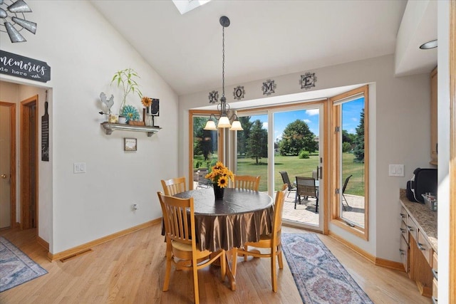 344 Prairie Ave, Winthrop Harbor, IL 60096 - dining room with light wood-style flooring, a chandelier, lofted ceiling, and a skylight
