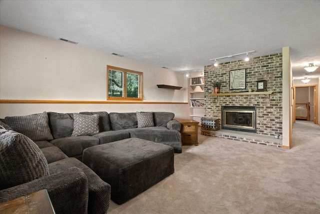 344 Prairie Ave, Winthrop Harbor, IL 60096 - carpeted living area featuring track lighting and a brick fireplace