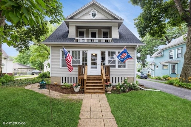 11610 2nd St, Huntley, IL 60142 - bungalow-style house featuring a balcony, a front lawn, and a shingled roof