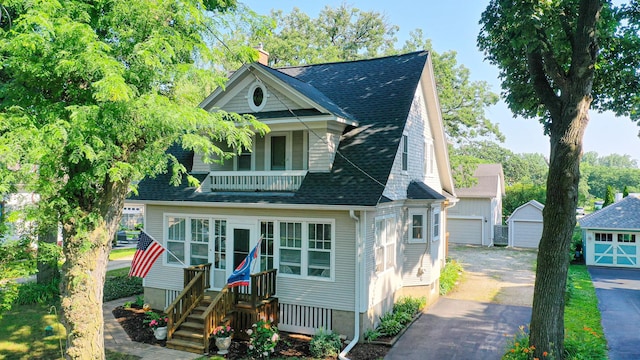 11610 2nd St, Huntley, IL 60142 - view of front of property with a balcony, a shingled roof, an outbuilding, a chimney, and a garage
