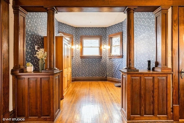 11610 2nd St, Huntley, IL 60142 - corridor with wallpapered walls, light wood-type flooring, and ornate columns