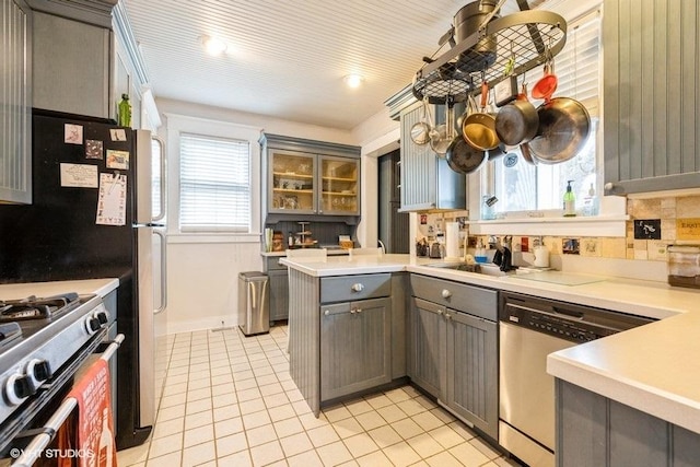11610 2nd St, Huntley, IL 60142 - kitchen with gray cabinets, appliances with stainless steel finishes, light tile patterned flooring, light countertops, and a peninsula