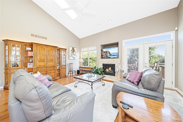 18011 Breckenridge Blvd, Orland Park, IL 60467 - living room with high vaulted ceiling, ceiling fan, a fireplace with flush hearth, light wood-type flooring, and french doors