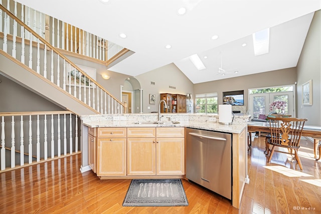 18011 Breckenridge Blvd, Orland Park, IL 60467 - kitchen with stainless steel dishwasher, light wood-style floors, a skylight, open floor plan, and light stone counters