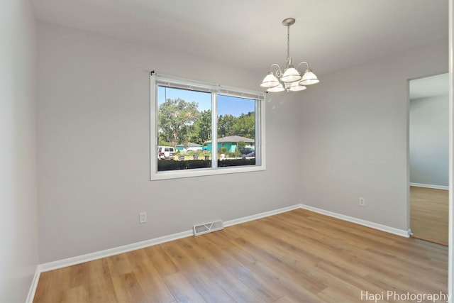 2029 Gabriel Ave, Zion, IL 60099 - spare room with a chandelier and light wood-type flooring