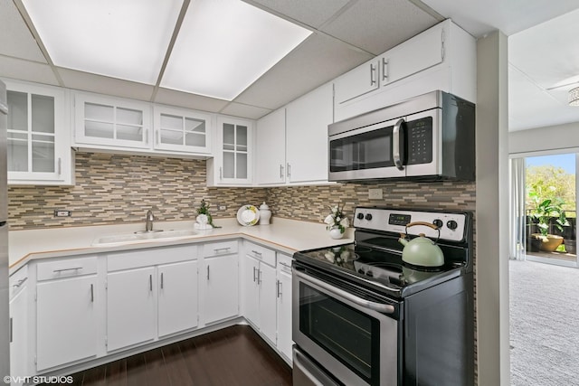 940 Holbrook Rd Unit 34C, Homewood, IL 60430 - kitchen with appliances with stainless steel finishes, light countertops, tasteful backsplash, white cabinetry, and a drop ceiling