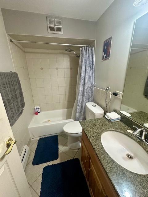 4342 N Kedvale Ave Unit 3C, Chicago, IL 60641 - bathroom featuring a baseboard heating unit, tile patterned floors, vanity, and shower / bath combo with shower curtain