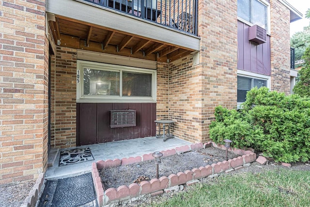 120A Collen Dr Unit 105, Lombard, IL 60148 - doorway to property featuring a balcony, brick siding, and a wall mounted AC