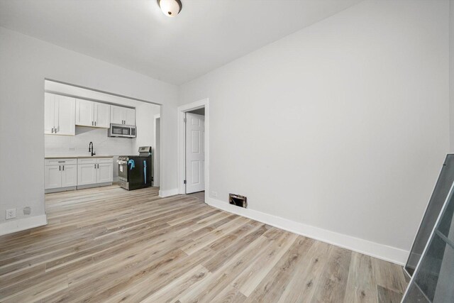 14137 Greenwood Rd, Dolton, IL 60419 - unfurnished living room with light wood-type flooring
