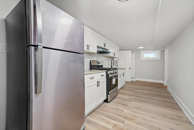 14137 Greenwood Rd, Dolton, IL 60419 - kitchen with appliances with stainless steel finishes, under cabinet range hood, light countertops, and white cabinetry