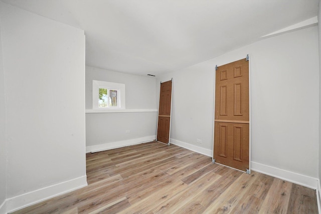 14137 Greenwood Rd, Dolton, IL 60419 - empty room with light wood-style floors and baseboards