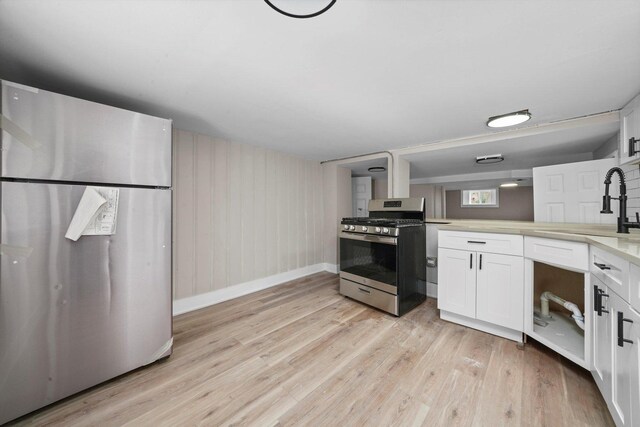 14137 Greenwood Rd, Dolton, IL 60419 - kitchen featuring appliances with stainless steel finishes, light wood finished floors, white cabinetry, and light countertops