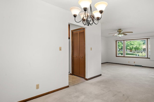 308 Long Ave, North Aurora, IL 60542 - spare room featuring light carpet, a chandelier, and a ceiling fan