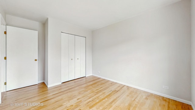 unfurnished bedroom featuring wood finished floors and a closet