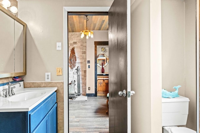 28231 US Highway 150, Leroy, IL 61752 - bathroom featuring vanity, a chandelier, wood finished floors, and wood ceiling