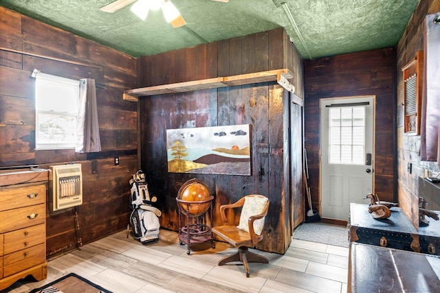 28231 US Highway 150, Leroy, IL 61752 - living area with wood walls, ceiling fan, heating unit, and wood tiled floors