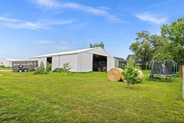 28231 US Highway 150, Leroy, IL 61752 - view of green lawn featuring a pole building, a trampoline, and an outdoor structure