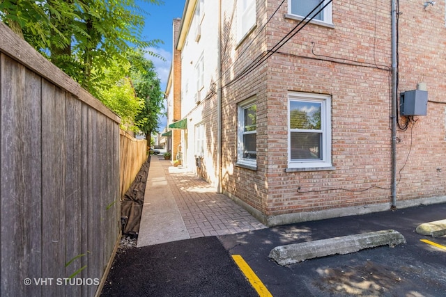 837 N Harlem Ave Unit 2N, Oak Park, IL 60302 - view of home's exterior with brick siding and uncovered parking