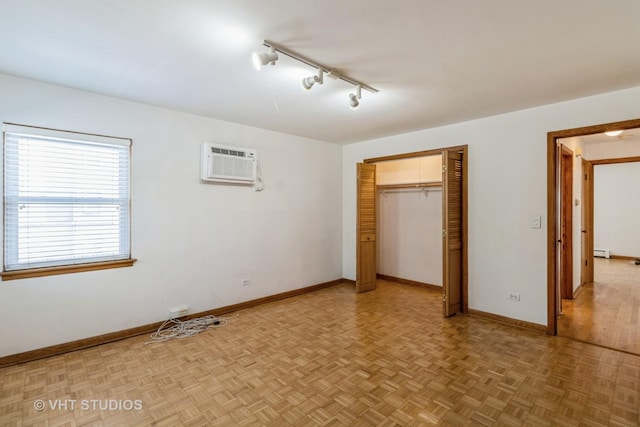 837 N Harlem Ave Unit 2N, Oak Park, IL 60302 - unfurnished bedroom with a wall mounted air conditioner, rail lighting, a closet, and baseboard heating