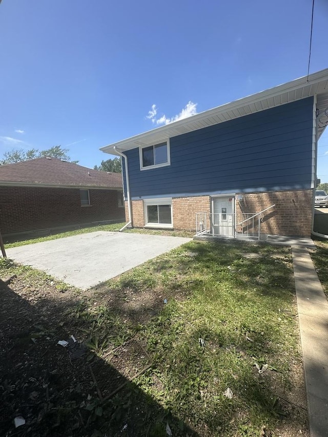 933 E 142nd St, Dolton, IL 60419 - back of house with brick siding and a yard