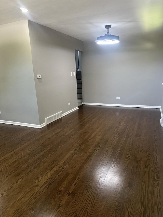 933 E 142nd St, Dolton, IL 60419 - empty room with dark wood finished floors and baseboards