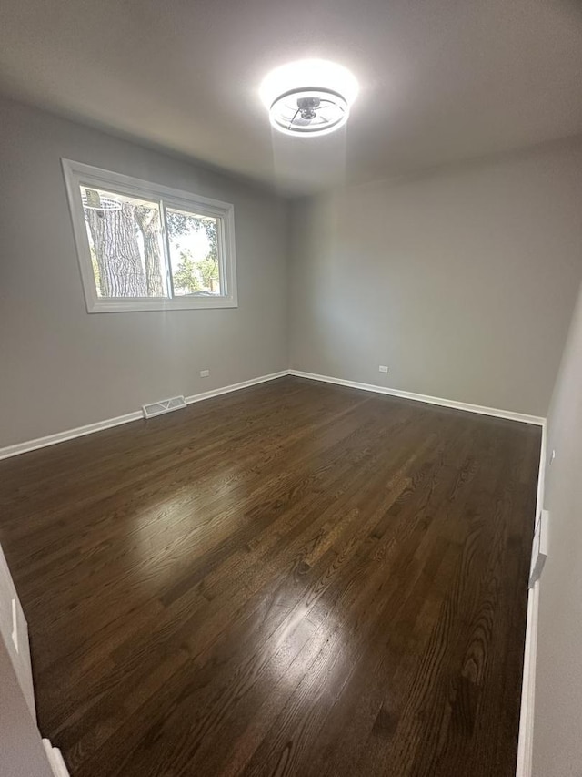 933 E 142nd St, Dolton, IL 60419 - unfurnished room featuring dark wood-type flooring and baseboards