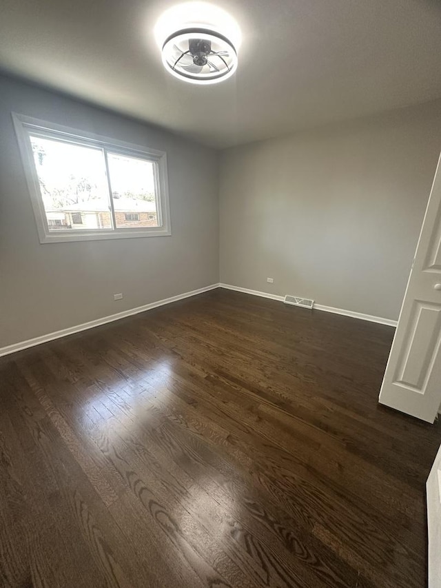 933 E 142nd St, Dolton, IL 60419 - unfurnished room with dark wood finished floors and baseboards