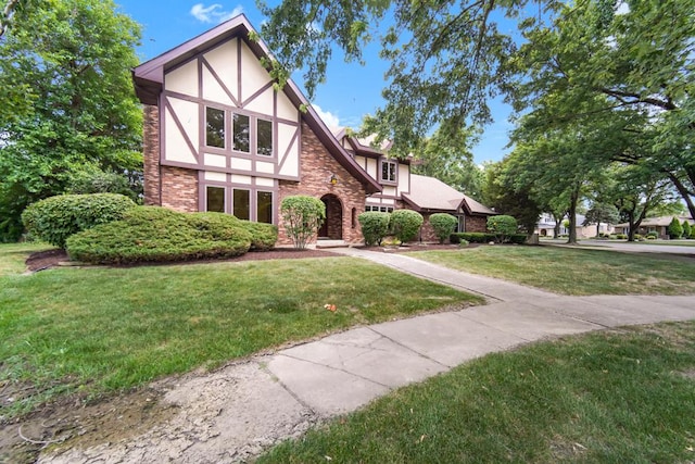 1234 Will Dr, Lockport, IL 60441 - tudor-style house featuring stucco siding, a front yard, and stone siding