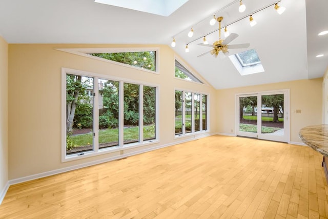 1234 Will Dr, Lockport, IL 60441 - unfurnished living room with a skylight, a ceiling fan, light wood-style floors, and high vaulted ceiling